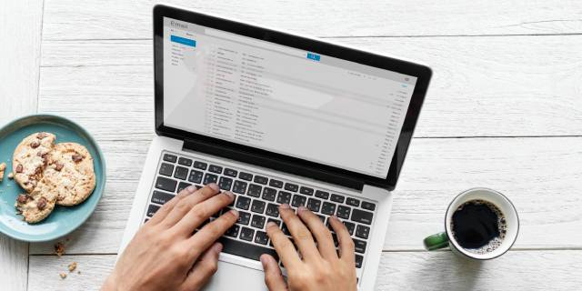 aerial-view-man-using-computer-laptop-wooden-table-1.jpg