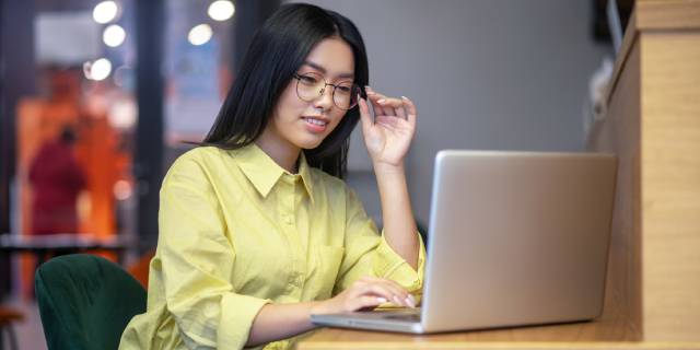 working-place-cute-asian-young-woman-eyeglasses-laptop-having-coffee-1.jpg